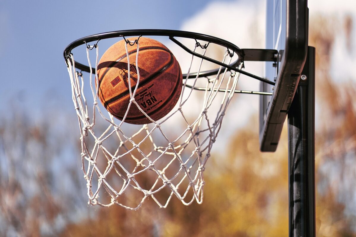 An adjustable basketball hoop set up on a driveway
