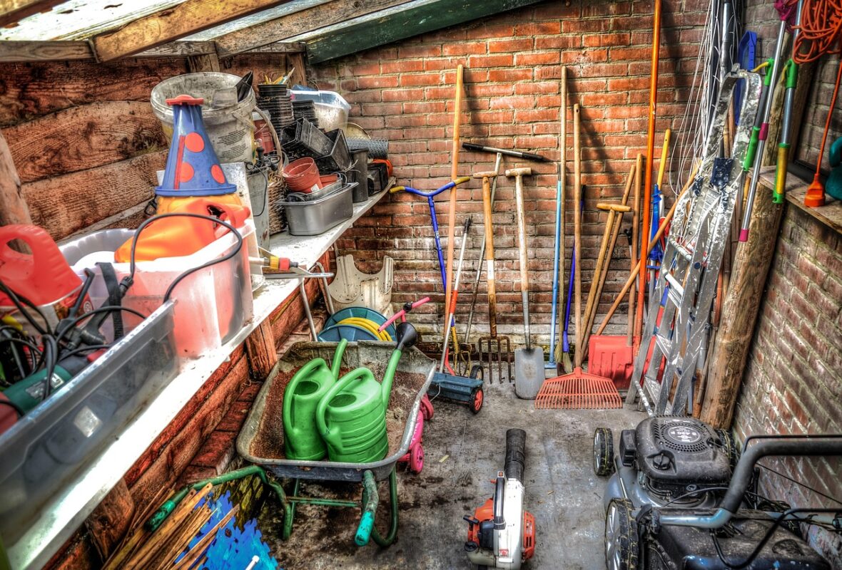 Outdoor play equipment covered and stored beside a shed