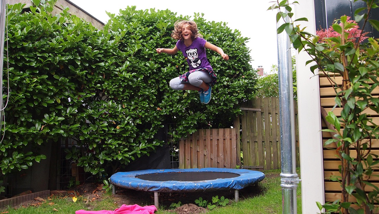 A small round trampoline set up on a lawn